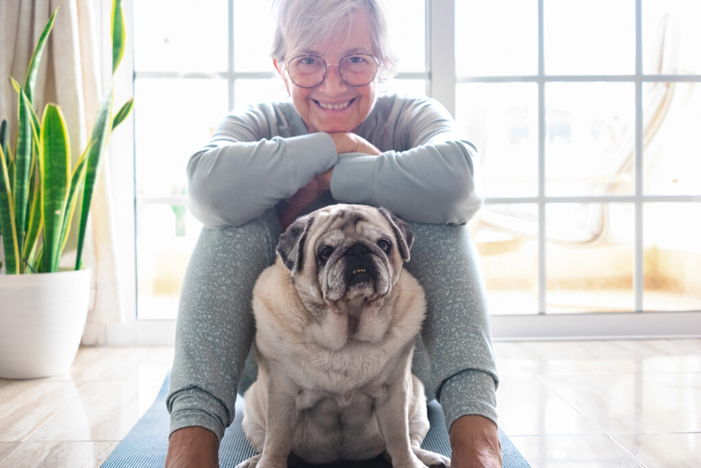 en äldre kvinna med en hund